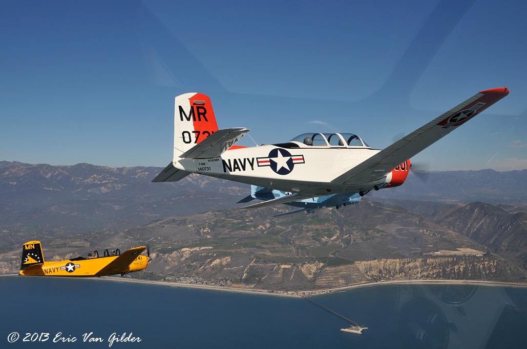 Three T-34 Mentors turning inbound for another
            pass.