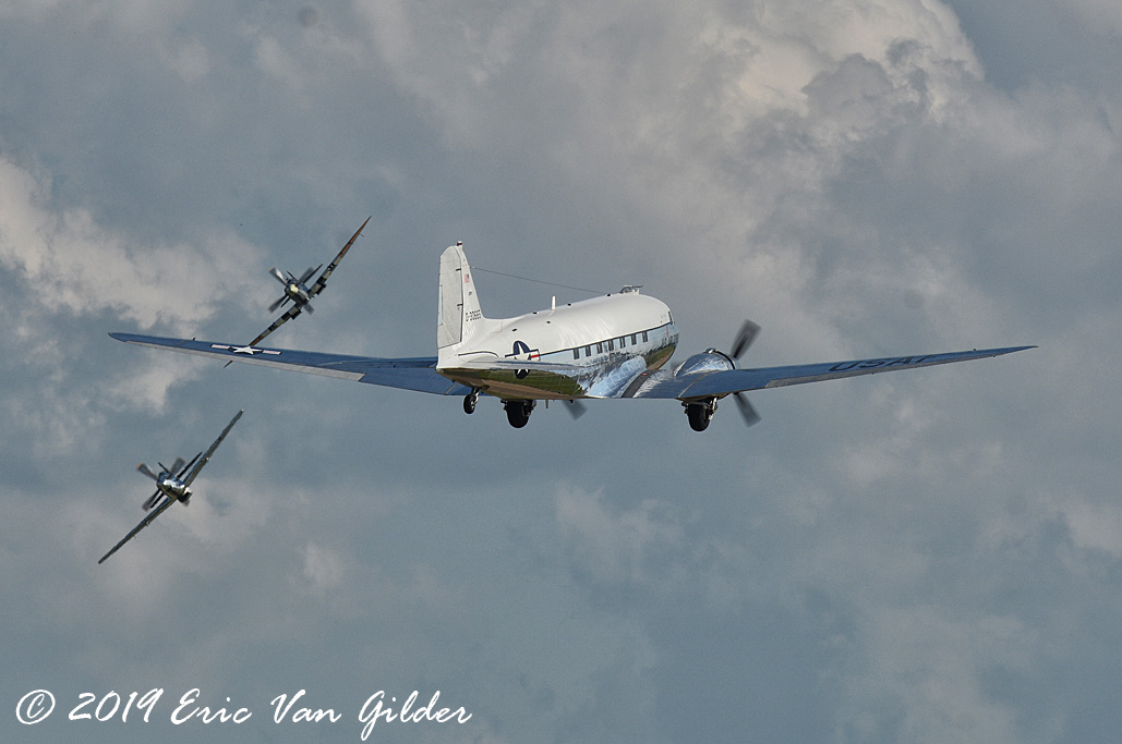C-47 taking off with
            a P-51 Mustang and Supermarine Spitfire inbound