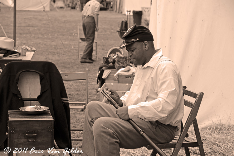 Union soldier cleaning his rifle