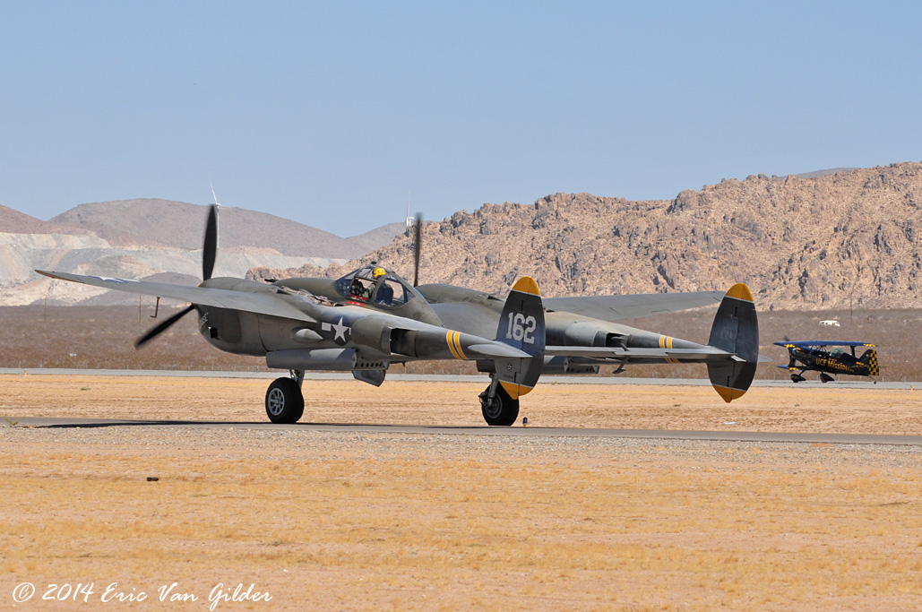 P-38 Lightning in the foreground and Jon Melby in
            the background
